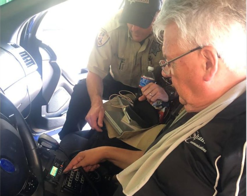 Clay Shank of Shank Communications from Jackson and Matthew Winstead of Neshoba Sheriff's Office go through configuration and instructions for use of the new MSWIN radios being installed in sheriff's office vehicles.